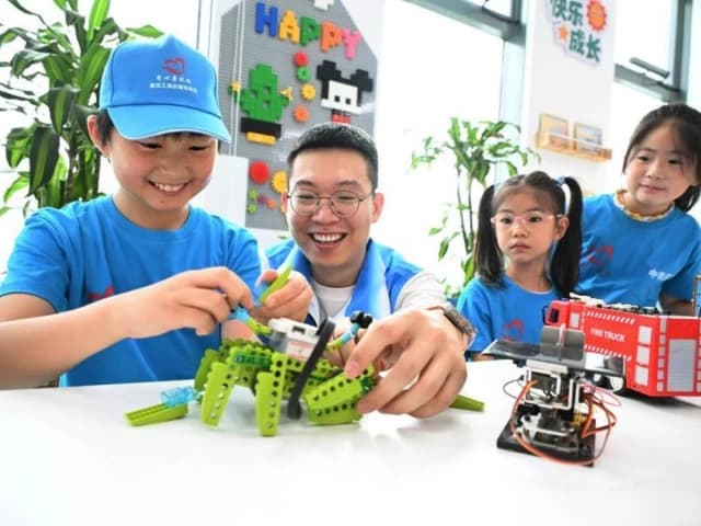 On a summer day, cheers erupted as clusters of children watched robots race across a soccer pitch