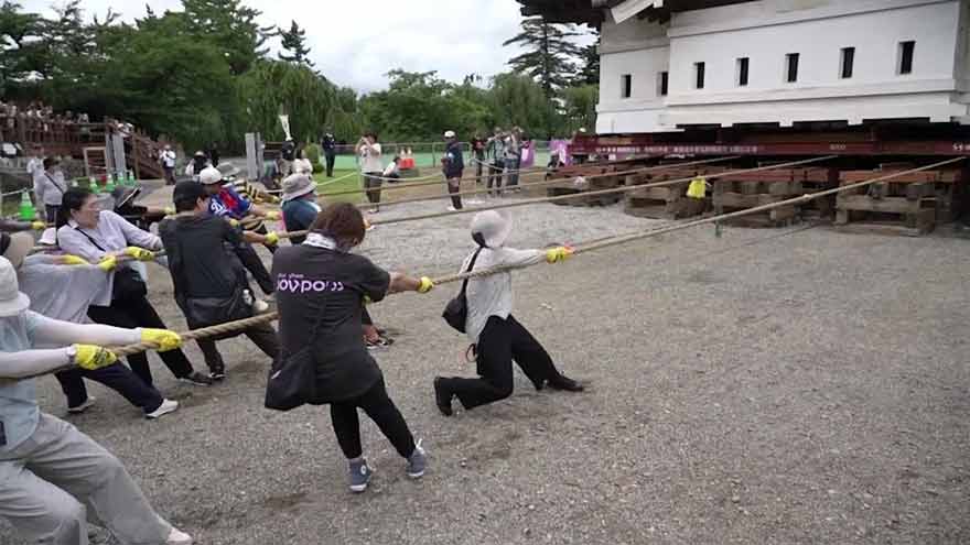 Japan's 400-tonne castle moves home — powered by thousands of hands